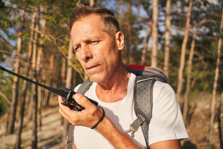Man going hiking with walkie talkie in nature