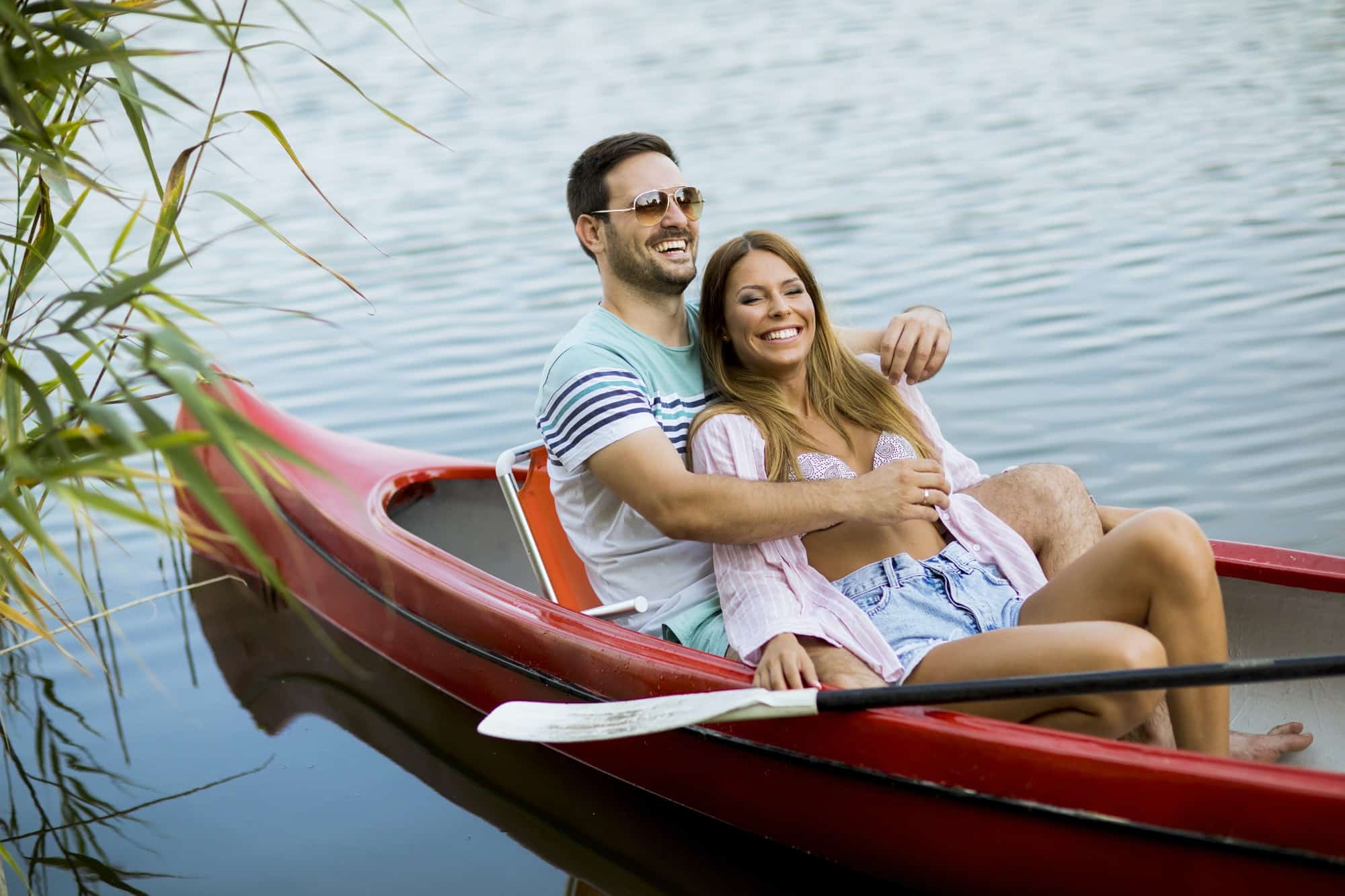 Adventure Sports And Outdoor Activities In The Lake District Close up portrait of romantic couple boating on the lake